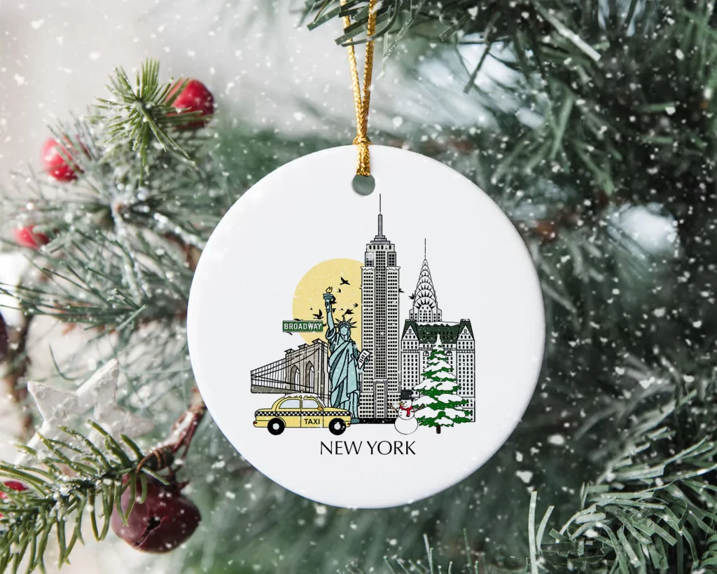 White ceramic ornament with illustrations of iconic New York things like the Statue of Liberty and a yellow taxi.